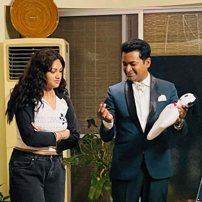 Prince Harun performing close-up magic with cards and coins